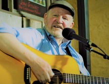Tom O'Donnell playing a guitar
